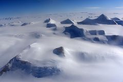 04G Mountains Pop Up From The Surrounding Glacier From Airplane Flying From Union Glacier Camp To Mount Vinson Base Camp.jpg
